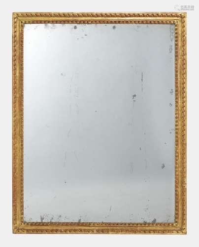 Miroir d'époque Louis XVI<br />
Bois sculpté et doré à motif...
