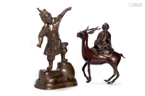 Two bronze sculptures depicting a warrior and a wise man rid...