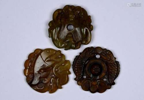 Three Chinese carved jade or other hardstone amulets