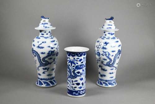 Three 19th century Chinese blue and white dragon vases in th...