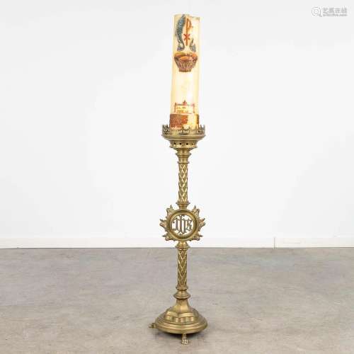 A large candlestick made of bronze, decorated with IHS logo....