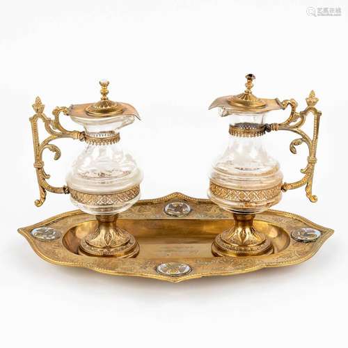 A pair of wine and water cruets made of glass and gold-plate...