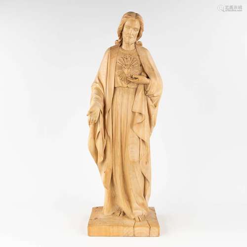 A wood-sculptured figurine of Jesus Christ with a Sacred Hea...