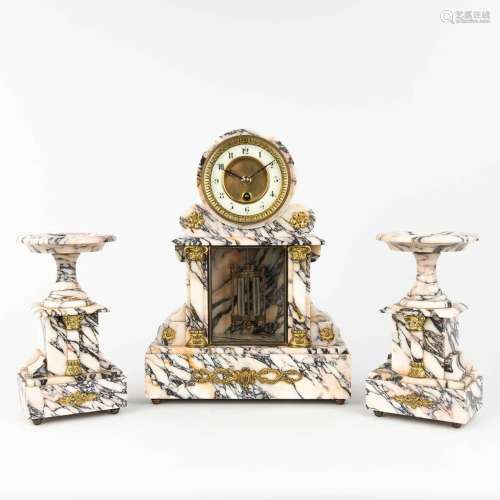 A three-piece garniture clock and side pieces, made of white...