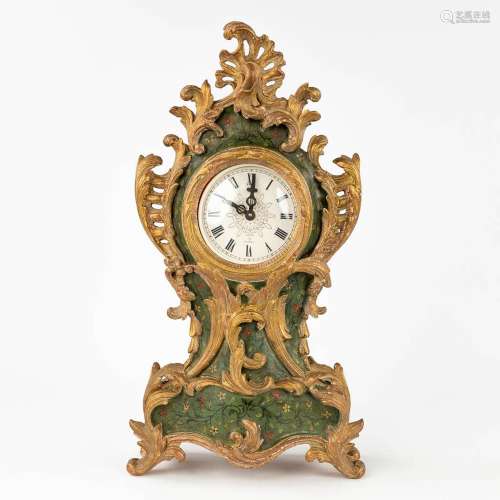 A wood-sculptured table clock in Louis XV style. (W: 25 x H:...