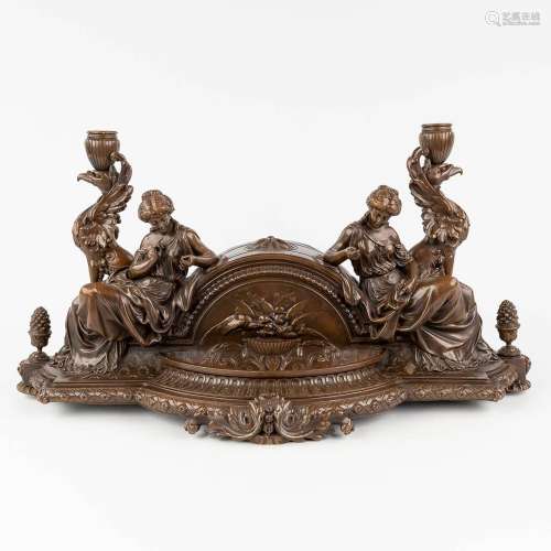 An antique mantle piece, decorated with female figurines and...