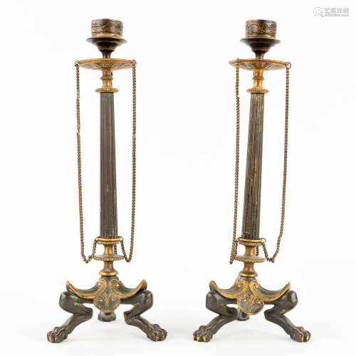 A pair of antique candlesticks, patinated and gilt bronze in...