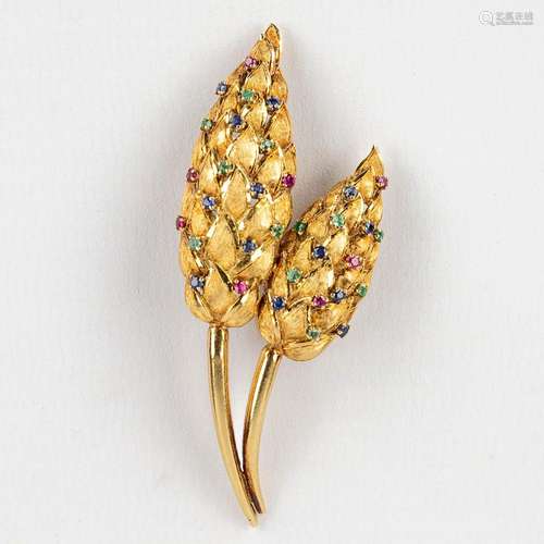 A brooche decorated with (semi-)precious stones. 18 karat go...