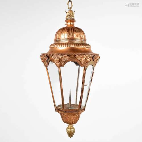 An antique lantern, made of copper and decorated with angles...