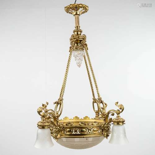 A large chandelier, bronze with glass shades a large bowl an...