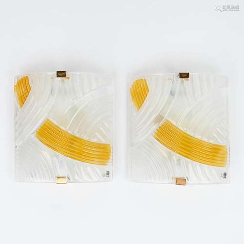 A pair of wall sconces, made of clear and yellow glass. Mark...