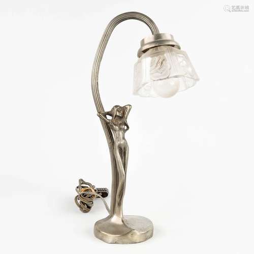 A table lamp with a naked figurine, glass shade. Spelter. (L...