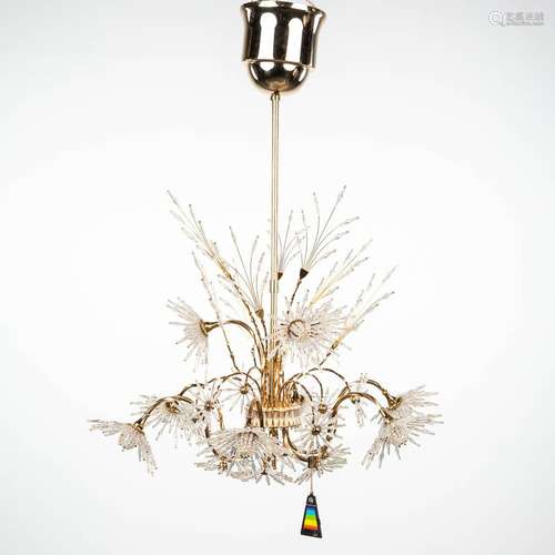 A vintage chandelier made of cut glass and marked Strass Swa...