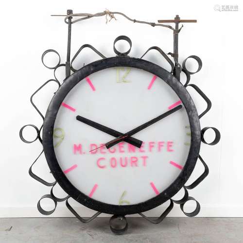 A large industrial double-sided hanging clock, marked M. Deg...