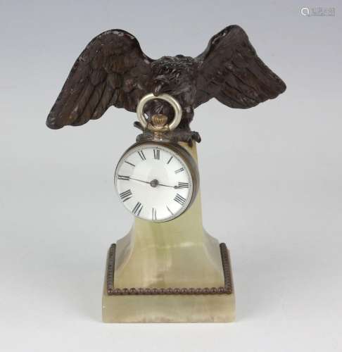 An early 20th century brown patinated bronze and onyx watch ...