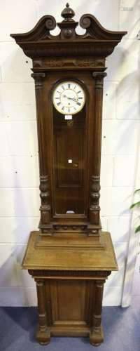 A late 19th century oak cased Vienna wall timepiece with cup...