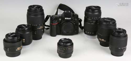 A Nikon D7100 camera body and a small group of Nikon lenses