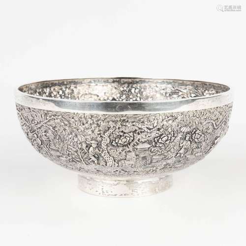 A Chinese bowl made of solid silver, decorated with animals,...