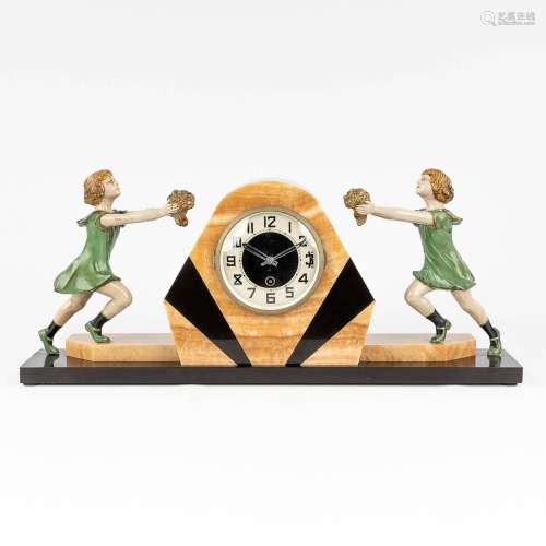 A mantle clock in art deco style with 2 children, onyx and s...