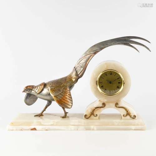 A mantle clock in art deco style with a pheasant, onyx and s...