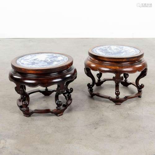 A pair of Chinese hardwood stands with a blue-white porcelai...