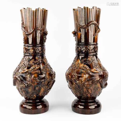 A pair of Chinese stoneware vases, decorated with relief dra...