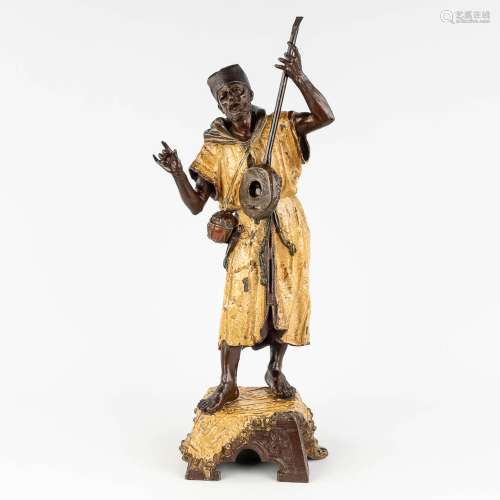 A large figurine of an Arab Bedouin, playing a musical instr...