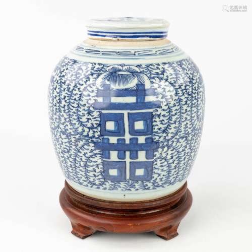 A Chinese vase with lid, decorated with blue-white Double Xi...