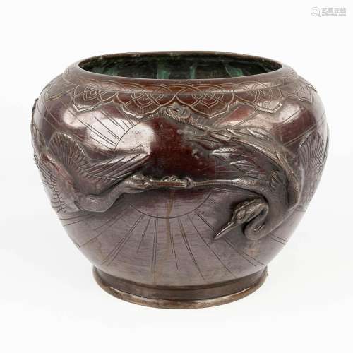 An Oriental cache-pot made of bronze and decorated with cran...