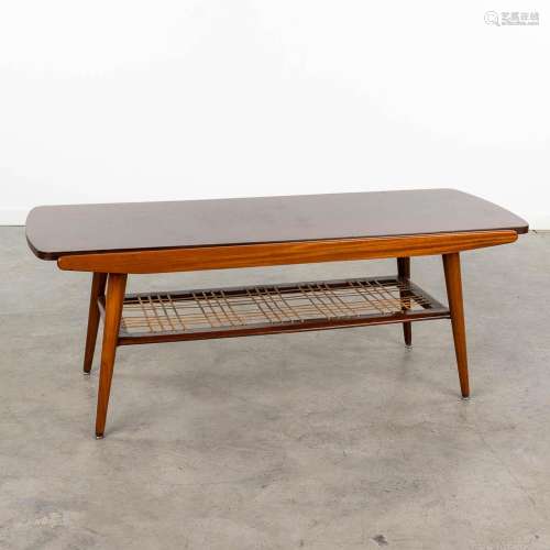 A mid-century coffee table with reversible table top, in the...