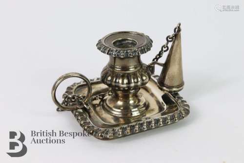 A silver Georgian chamber stick candle holder with extinguis...