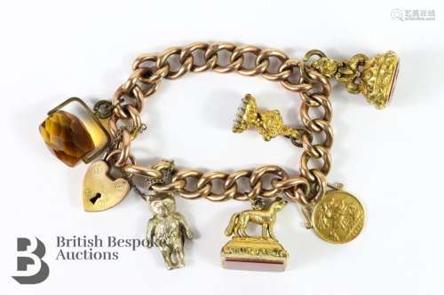 9ct gold charm bracelet. The bracelet having one 1914 George...