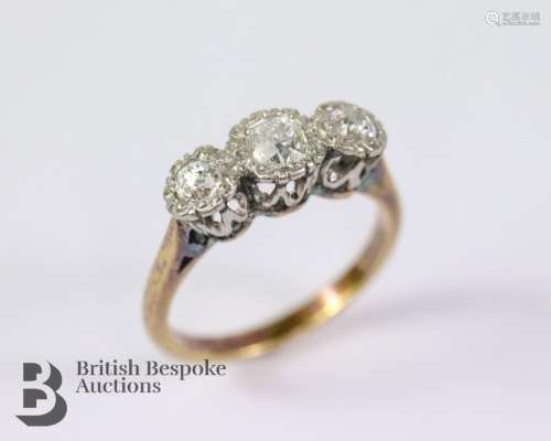 18ct and platinum three-stone diamond ring. The ring set wit...