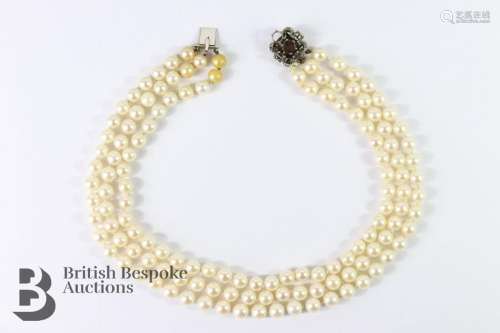 Three strand cultured pearl and a couple of synthetic pearl ...