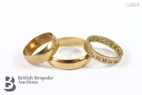 Two 9ct gold wedding bands and a 9ct gold white-stone eterni...