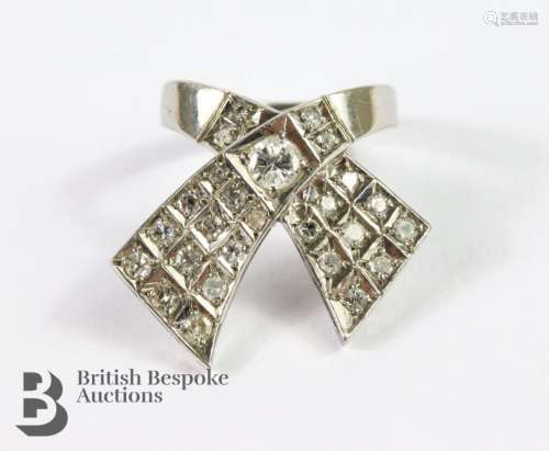 White gold and diamond ribbon ring. The ring set with approx...