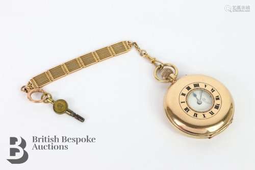 A 9ct gold half hunter pocket watch. The watch having a whit...