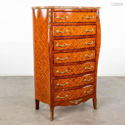 A 7-drawer cabinet finished with marquetry inlay and mounted...