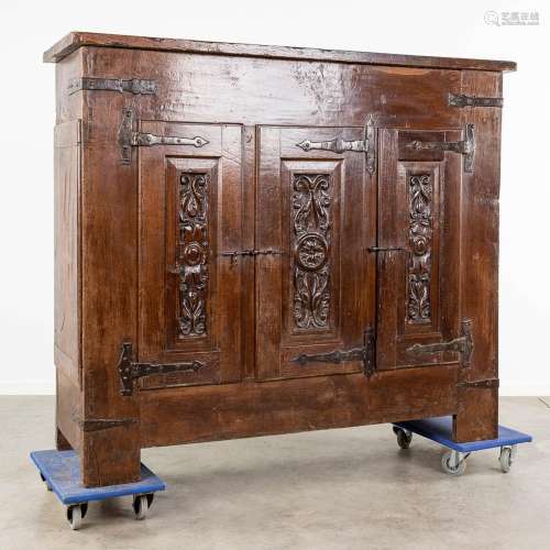 An antique three-door cabinet with sculptured oak doors, Fra...