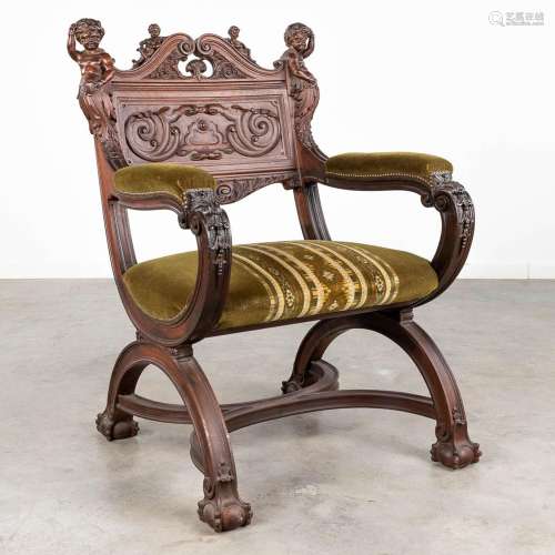 An armchair made of sculptured walnut in Italian renaissance...