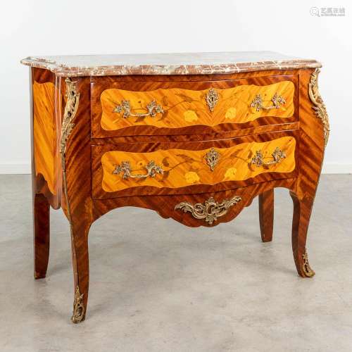 A commode chest of drawers decorated with marquetry inlay an...