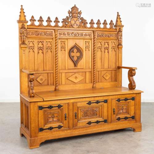 A large and antique bench finished with wood sculptured in a...