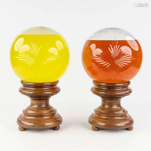 A pair of 'Boulles De Pharmacie', large glass spheres with l...