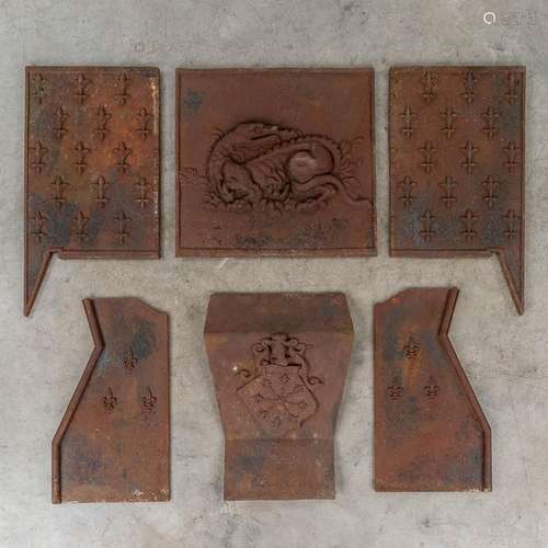 The interior of a fireplace finished with fleur de lis and d...