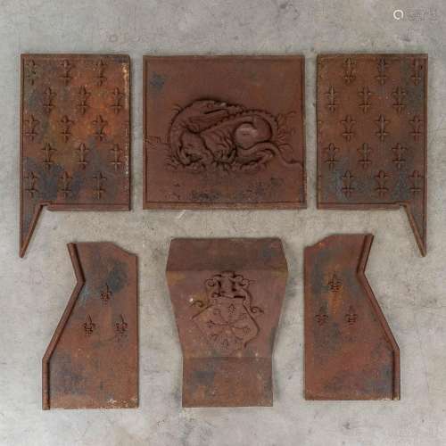 The interior of a fireplace finished with fleur de lis and d...