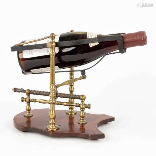 An antique mechanical wine decanting cradle, made of mahogan...