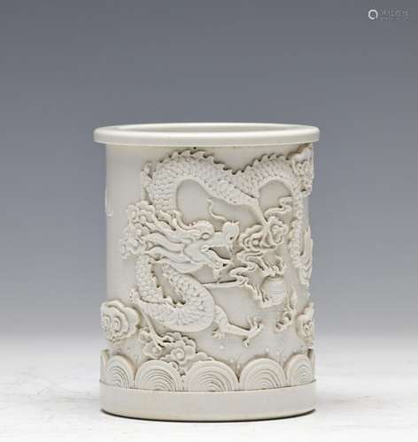 QING, WHITE GLAZED LOW RELIEF 'DRAGON' BRUSH POT