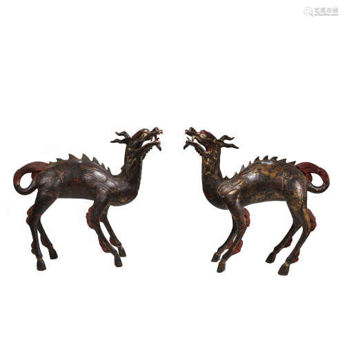 A PAIR OF CHINESE QING DYNASTY GILT BRONZE UNICORN ORNAMENTS