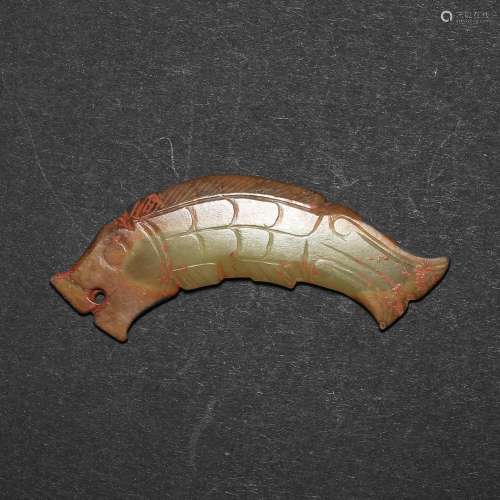 A BROWN AND RUSSET 'FISH' JADE PENDANT