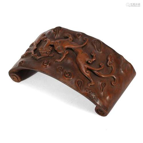 A CARVED BAMBOO 'BEAST' BRUSH REST